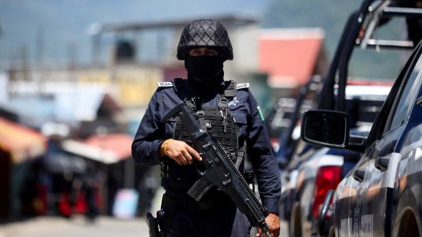 Police conduct an operation near the border with Guatemala following clashes with gunmen, in Las Champas