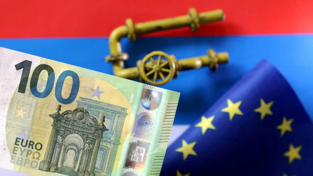 FILE PHOTO: Illustration shows model of natural gas pipeline, Rouble banknote, Russian flag and torn EU flag