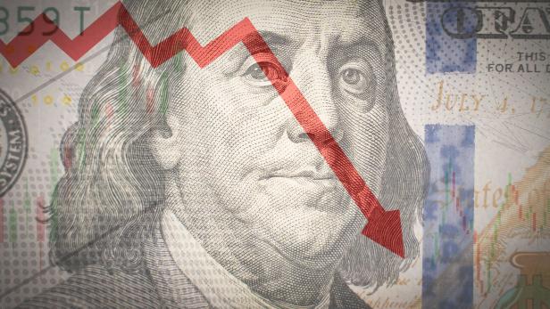 One hundred dollar bill on the background red downward arrow. Economic crisis.