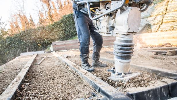 Man Using Rammer Tamper (Jumping Jack) for Soil Compacting