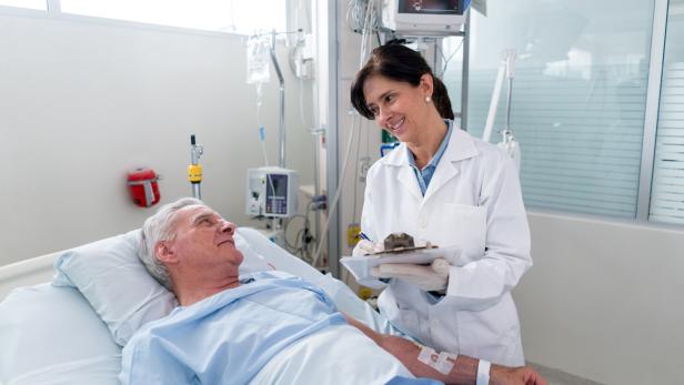 Doctor checking on a patient at the ICU