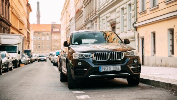 Front View Of Black BMW X6 F16 Car Parked In Street. Front View Of Black BMW X6 F16 Car Parked In Street.