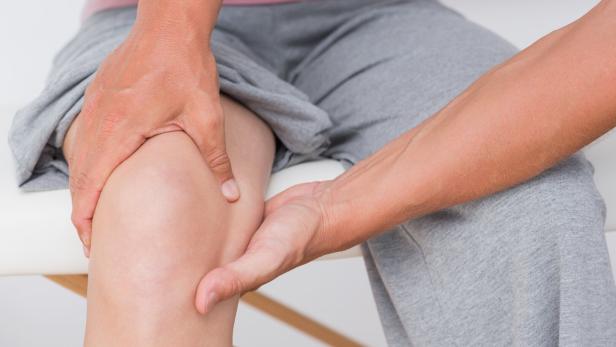 Doctor examining his patient knee