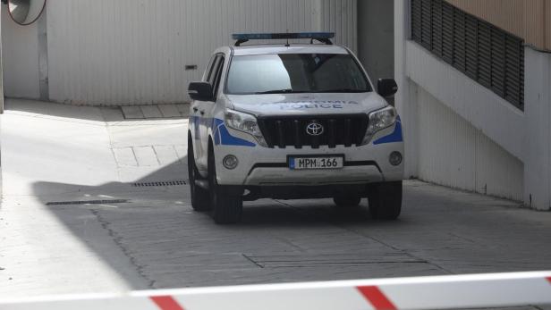 David Hunter, British pensioner facing murder charges over the death of his wife, leaves in a police car from a courthouse in Paphos