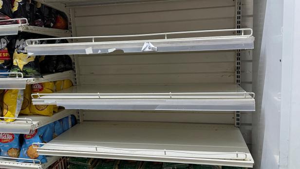 Empty shelves are seen in the rice section inside a supermarket in Tunis