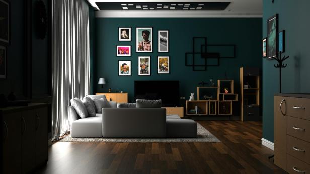 Wohnzimmer mit dunklen grünen Wänden und Holzböden, gemütlich und einladend gestaltet.