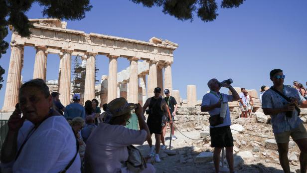 Tourists visit the Acropolis during a 3-days heatwave in Greece