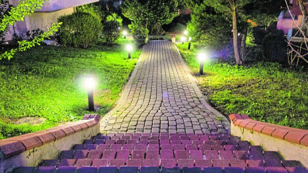House and garden in city at midnight