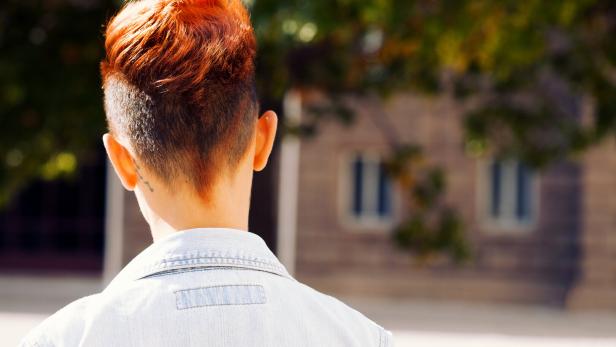 Rear view of a redhead woman