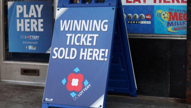 FILE PHOTO: Lotto ticket signs advertising Mega Millions and the Powerball