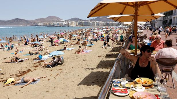 FILE PHOTO: Tourists eat on a terrace next to Las Canteras Beach in Las Palmas de Gran Canaria