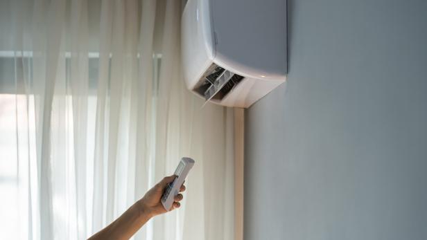 Owner tries to turn on air conditioner to allow stream of warm air to make apartment hotter Owner tries to turn on air conditioner to allow stream of warm air to make apartment hotter