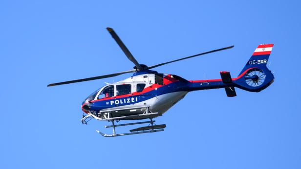 Ein Polizeihubschrauber vor einem blauen Himmel.