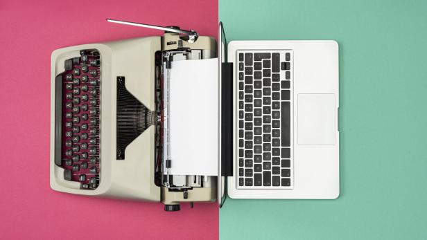 Classic analog typewriter vs Modern digital hi-tech laptop computer