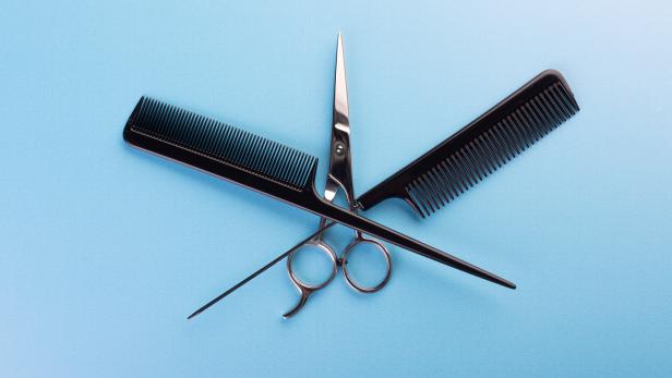 Professional tools for hairdresser on blue background