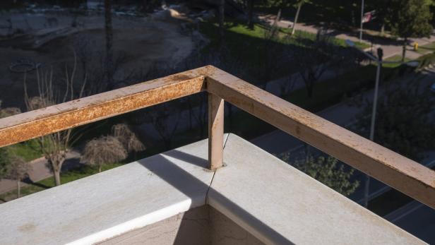 dirty and rusted balcony rail