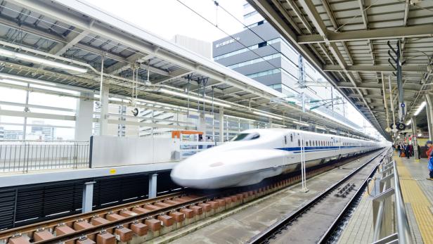 Shinkansen train departs from rail station in Japan