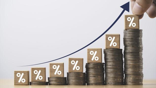 Increasing coin stacking with up arrow and percentage sign for increase financial interest rate and business investment growth from dividend concept. Increasing coin stacking with up arrow and percentage sign for increase financial interest rate and business investment growth from dividend concept.