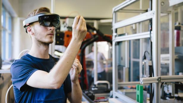 industry 4.0: Young engineer works with a head-mounted display