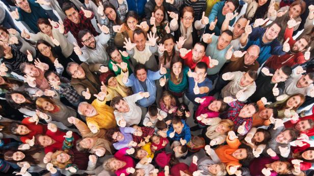 High angle view of crowd of people showing thumbs up. High angle view of crowd of people showing thumbs up.