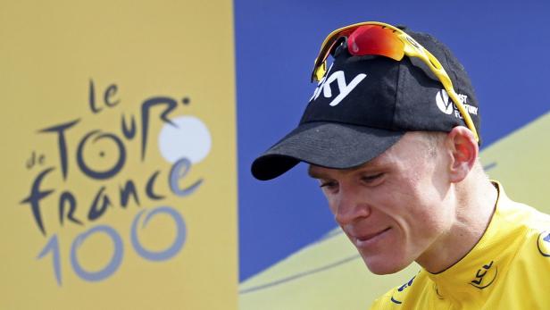 Team Sky rider Christopher Froome of Britain celebrates his race leader yellow jersey on the podium of the 242.5 km fifteenth stage of the centenary Tour de France cycling race from Givors to Mont Ventoux July 14, 2013. REUTERS/Jean-Paul Pelissier (FRANCE - Tags: SPORT CYCLING)