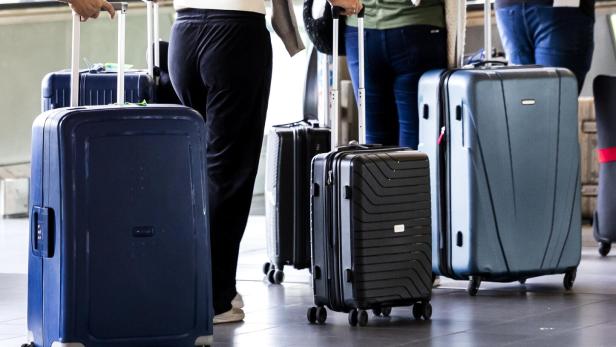 Travelers with their luggage at Schiphol Airport near Amsterdam