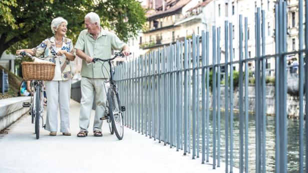 Senior couple with their bikes on city street
