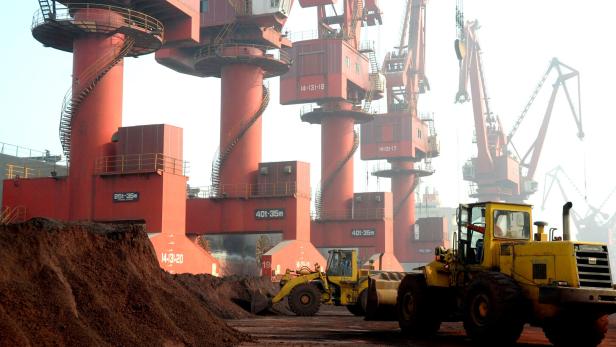 FILE PHOTO: Workers transport soil containing rare earth elements for export at a port in Lianyungang