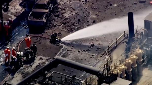 Firefighters spray water on the site of an explosion at U.S. Steel's Clairton Coke Works plant in Clairton