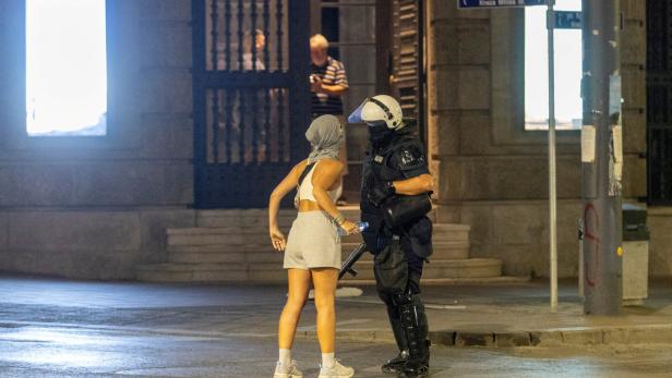 A demonstrator argues with a Serbian police officer during standoff between ruling party supporters and anti-government protesters in Belgrade A demonstrator argues with a Serbian police officer during standoff between ruling party supporters and anti-government protesters in Belgrade