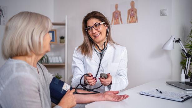 Mature adult woman has her blood pressure checked