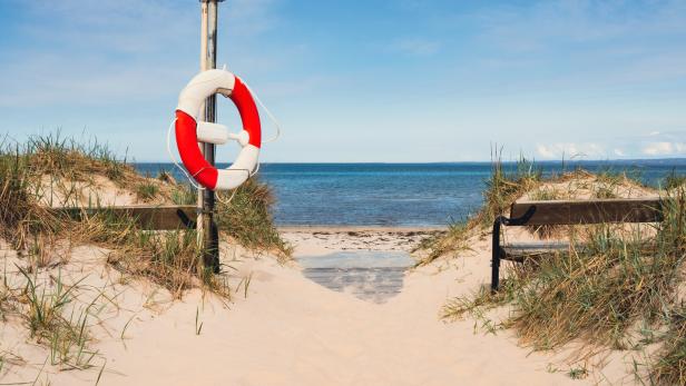 Benches on a beautiful white sand beach in south Sweden. Popular tourist destination.