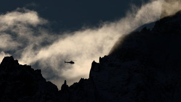 A helicopter of the High Mountain Gendarmerie Platoon (PGHM) rescue service flies over the Mont-Blanc region in Chamonix