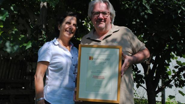 Enrica Innocenti und Martin Stelczmayer mit einer Urkunde in der Hand