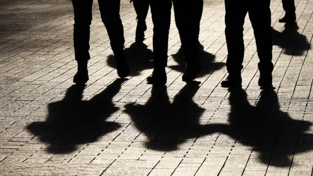 Silhouettes and shadows of people on the street
