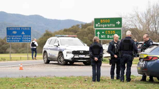 Victorian Police stand at the scene of a shooting in Porepunkah