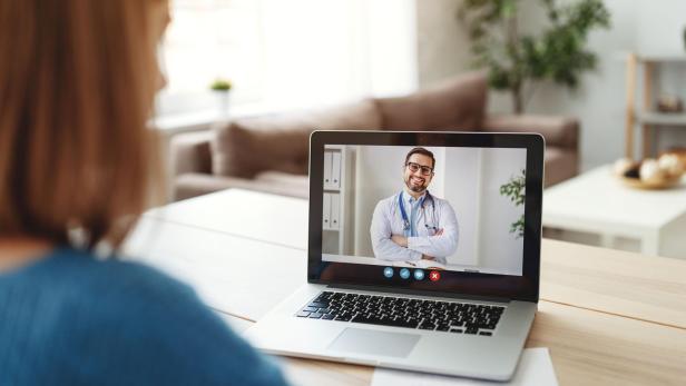 Woman making video call to doctor