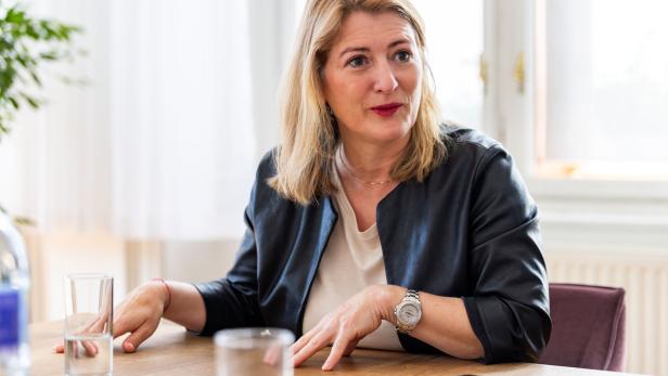 Bettina Emmerling von den Neos sitzt an einem Tisch.