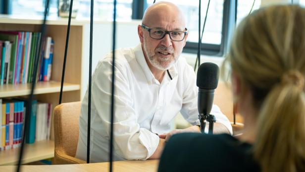 oebv Geschäftsführer Philipp Nussböck bei einem Interview mit Mikrofon, eine Frau sitzt ihm gegenüber