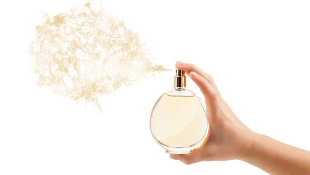 woman hands spraying perfume