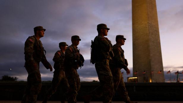 FILE PHOTO: Members of the National Guard walk at the National Mall after U.S. President Trump deployed National Guard troops and ordered an increased presence of federal law enforcement to assist in crime prevention, in Washington FILE PHOTO: Members of the National Guard walk at the National Mall after U.S. President Trump deployed National Guard troops and ordered an increased presence of federal law enforcement to assist in crime prevention, in Washington