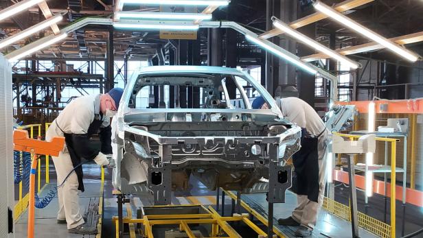 FILE PHOTO: Employees work at the assembly line of the LADA Izhevsk automobile plant in Izhevsk FILE PHOTO: Employees work at the assembly line of the LADA Izhevsk automobile plant in Izhevsk