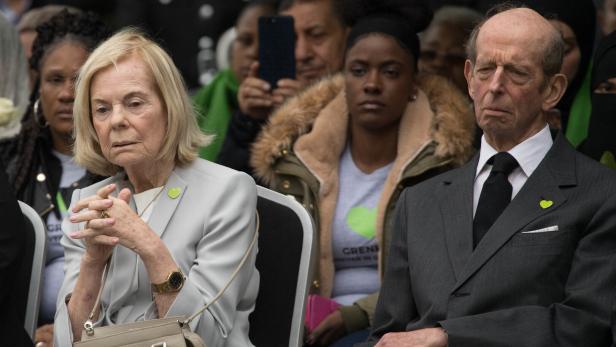 Der Herzog und die Herzogin von Kent (2018) Der Herzog und die Herzogin von Kent sitzen formell gekleidet in einer Menschenmenge, beide tragen grüne Herz-Anstecker.