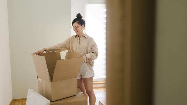 Young woman moving in new house and online shopping Young woman moving in new house and online shopping