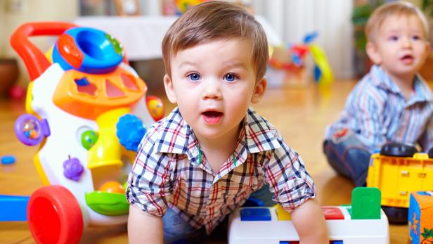 curious baby boy studying nursery room