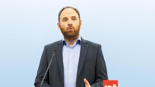 Ein Mann mit Bart spricht am Rednerpult mit dem Logo der SPÖ.