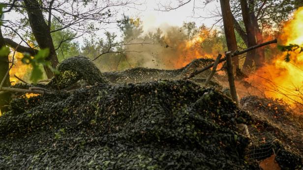 Service members of the 24th Separate Mechanized Brigade of the Ukrainian Armed Forces fire a 2S3 Akatsiya towards Russian troops on the front line, in Donetsk region
