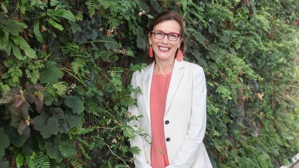 Ursula Wiedermann-Schmidt posiert vor einer grünen Wand.