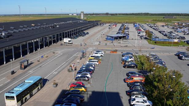 Vehicles are parked at Aalborg Airport
