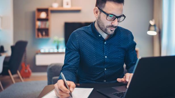 Worried businessman checking financial numbers